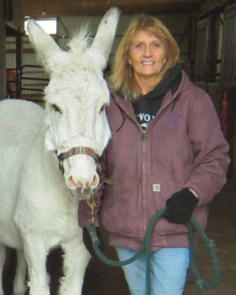 Healing Barn Founder and Director Nancy Swigart, with barn mascot Jack the donkey, who turned 34 this year.