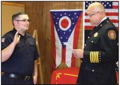 Fire Chief Tom Brice, right, swears in the newest full-time firefighter Jerod Wright. He began duty on September 9 with a starting hourly salary of $24.99.