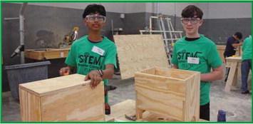 Rishabh Jha, an eighth grader, and Ethan Brown, ninth grader at Rossford schools, learn how to construct wooden storage boxes.