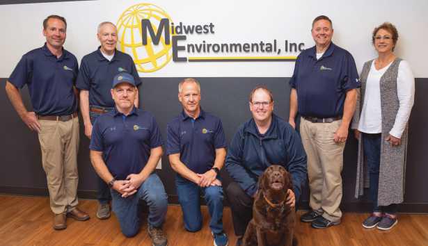 Above are, standing from left: David Bruhl, Dale Bruhl, Jr., Dan Wilburn, Lisa Sekela. Kneeling from left: Frank Montgomery, Scott Sellers, Justin Reitz and Darcy the company mascot.