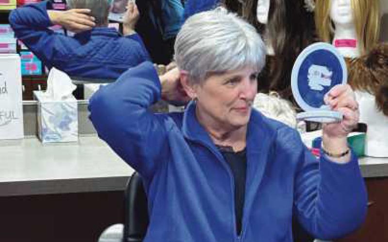 Peggy Keyes tries on her new wig.