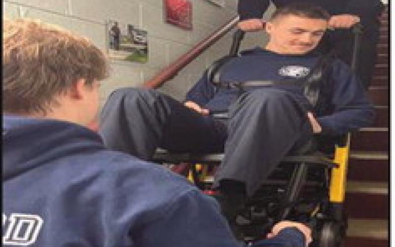 Fire and rescue members practice using a stair chair.