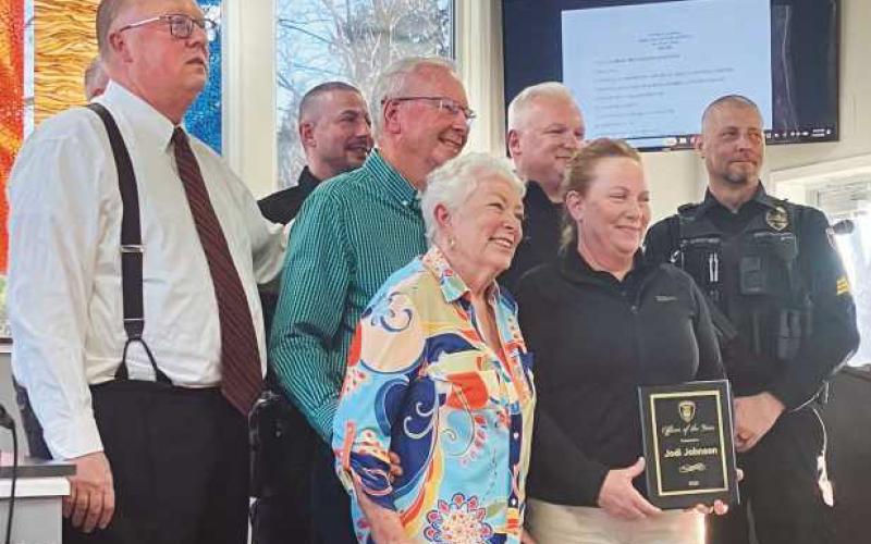 Officer Jodi Johnson (second from right) with her parents (to her left), her fellow officers and Mayor MacKinnon (far left).
