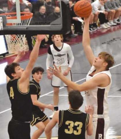 Derek Vorst goes up for the shot during the Perrysburg game. The junior post player tallied 10 points in the opening quarter with two three-point shots and a dunk. Photo by John Bauer