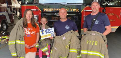 Alona Matchenko, president, Toledo Helps Ukraine; her daughter, Jasmine, and Perrysburg Township Firefighter/Paramedics Mike Thompson and Branden Abke, show some of decommissioned turnout gear donated by the Perrysburg Township Fire Department to be shipped to Ukraine by THU.