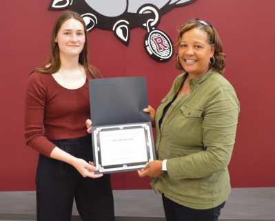 Dawn Burks, school board president, presents Mia DeBortoli with a commendation for her accomplishments in track and field. This year, Mia qualified for state in the 200m by finishing fourth at regionals. Her 4x200m relay team finished second in the Northern Buckeye Conference to qualify for regionals. Mia also finished First Team All-NBC in 200m; received honorable mention in the NBC 100m, and played on the varsity girls basketball team.