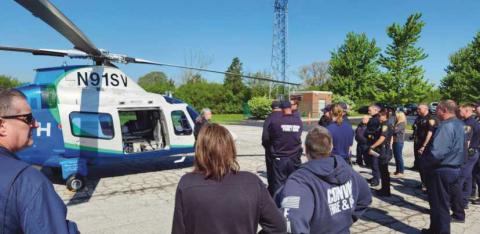 By Walter Celley Pilot Meghan Newyear instructs first responders on helicopter landing zone safety.