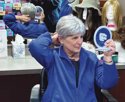 Peggy Keyes tries on her new wig.