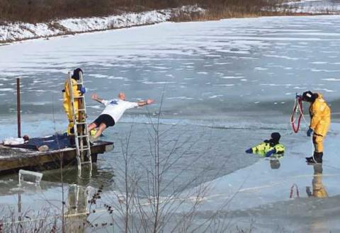 Bulldog Foundation vice president Doug Miller falls back-first into the frigid waters.