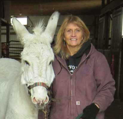 Nancy Swigart, founder and director of the Healing Barn, with barn mascot Jack the donkey.