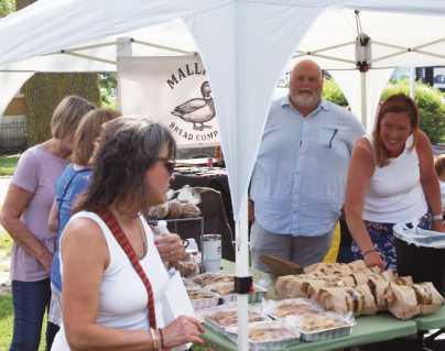 Stroll the Street attendees peruse bread and baked goods.