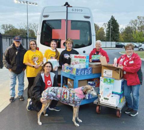 From left: James McVicker, Ella Cole, Kim Ferguson and Bubbles, Leah Gladieux, Martha Fellman, Gloria Liedigk and Kathy McVicker with donations for the 180th.