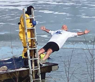 Bulldog Foundation Vice President Doug Miller falls backfirst into the frigid waters.
