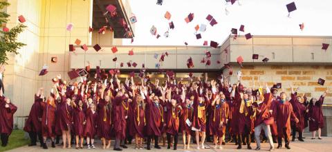 Following commencement ceremonies, Rossford graduates celebrate with the traditional tossing of their caps.