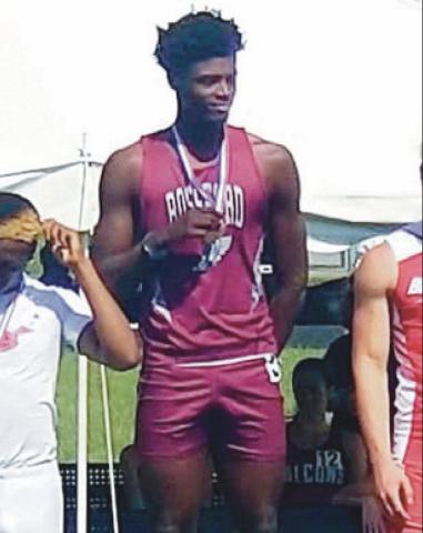 Above, RHS senior Jamari Croom stands atop the podium at the state track championship. Minutes later, he was congratulated, below, by another RHS state champ Ron Weber. Mr. Weber was at the meet cheering Jamari on exactly 50 years after earning his own state titles in the 120 yard high hurdles and the 180 yard low hurdles. “A class act all around, it was so cool to see one Rossford legend welcome another into legendary status,” said RHS head track coach Todd Eckel.