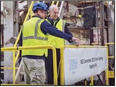 Joe Gyurasics and Todd Huffman press the button for the ceremonial furnace lighting.