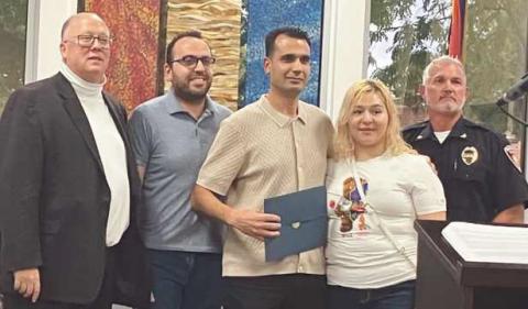 Mohammed Tahar (center) with Mayor MacKinnon (far left), Chief Kitzler (far right) and Tahar’s family.