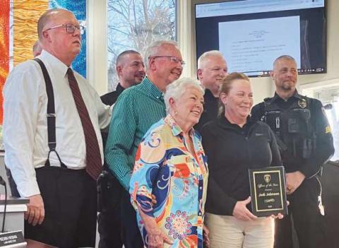 Officer Jodi Johnson (second from right) with her parents (to her left), her fellow officers and Mayor MacKinnon (far left).