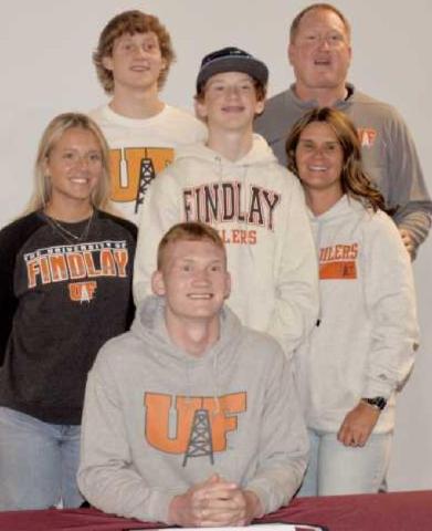 On Signing Day, Ben, seated center, was joined by family members from left, middle row: Olivia, Max and mother Nicole, and back row: Jake and father Brad.
