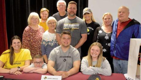 On Signing Day, Gavin, seated center, was joined by family members–standing from left, his grandmother Mary Smith, Logan Gauthier, grandmother Pat Linkous, grandfather Larry Linkous, parents Greg and Rachel Linkous, aunt Sarah Larson and grandfather Dennis Blair. Seated from left are his girlfriend Rylin Reynolds, brother Kaiden and sister Kelsey.