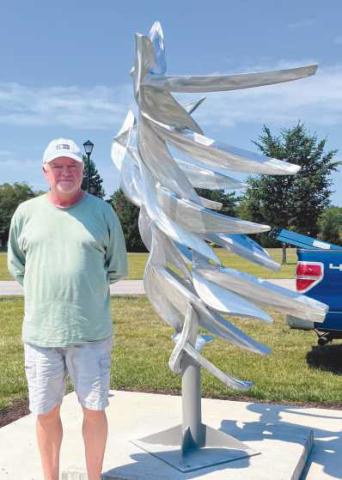 Artist Michael Young with his sculpture Quantum Flock.