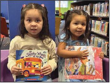 Left to right: Lavariah and Ameliah with their new books.