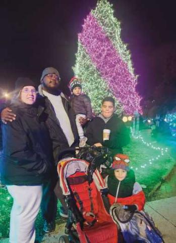 From left: Jessica Fausnaugh, Lendale Rogers Jr., Christian Rogers, Isaiah Walton and Lendale Rogers III press paws at the Toledo Zoo’s Lights Before Christmas.