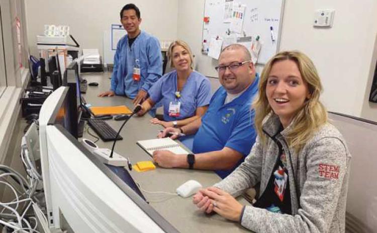 Members of the cath lab team explain process and teamwork to teacher Lauren Myers, R.N.; Adam Holcombe, Elmwood special education teacher; Tracey Jarrett, R.N., and John Mark Naila, R.N.