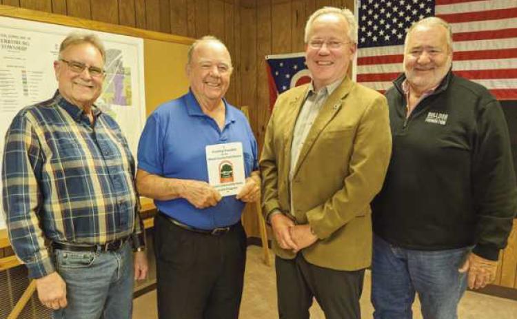 The Wood County Park District director presented the trustees with a plaque commemorating their park district grant. From left are Trustee Gary Britten, Recreation Director Bob Warnimont, who applied for the grant, and Trustees Bob Mack and Joe Schaller.