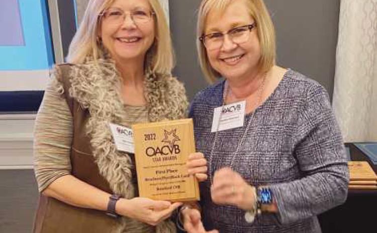 Beth Genson, (left), executive director of the Rossford CVB, accepts a STAR Award from Debbie Robinson, president of the OACVB, at the annual conference.