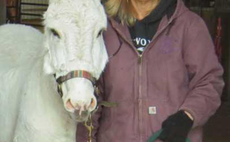 Healing Barn Founder and Director Nancy Swigart, with barn mascot Jack the donkey, who turned 34 this year.