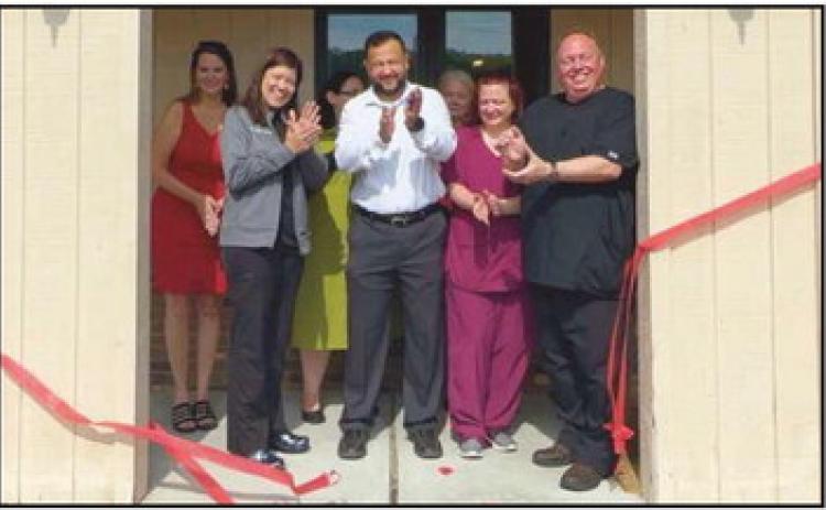 Dr. Walid Mahmoud, M.D., and the care team celebrate its ribbon-cutting ceremony.