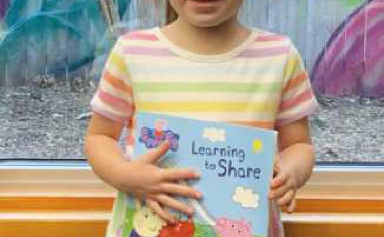 Rossford adds new member to 1,000 books club