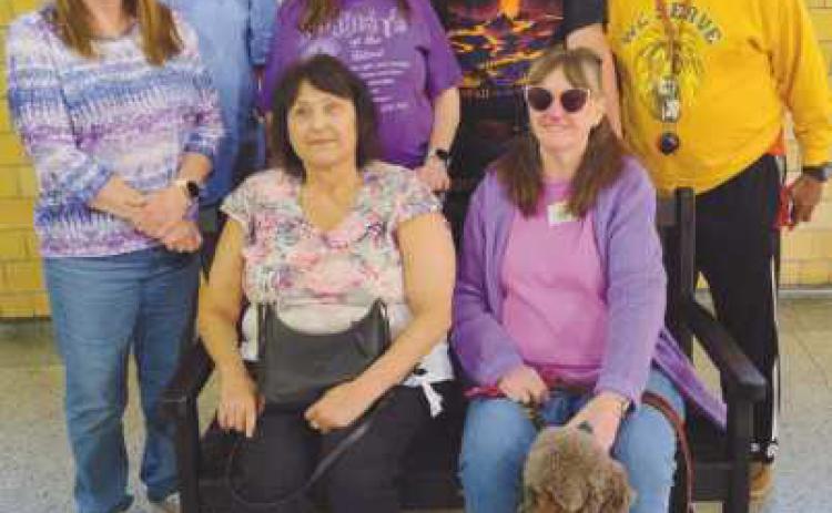 Club members on the TREX bench they earned by recycling 1,000 pounds of pastic. The bench will be installed for public use in Perrysburg.
