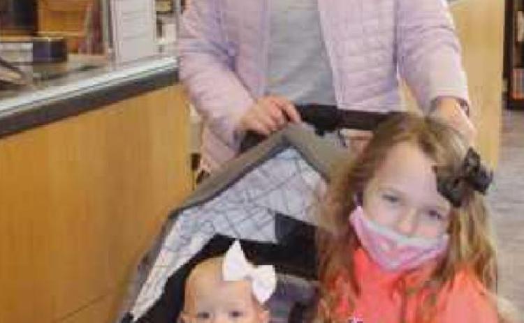 Clerissa Seamons of Rossford and her daughters Ivy, 1, and Emilia, 4, visited the library to check out some books last week.