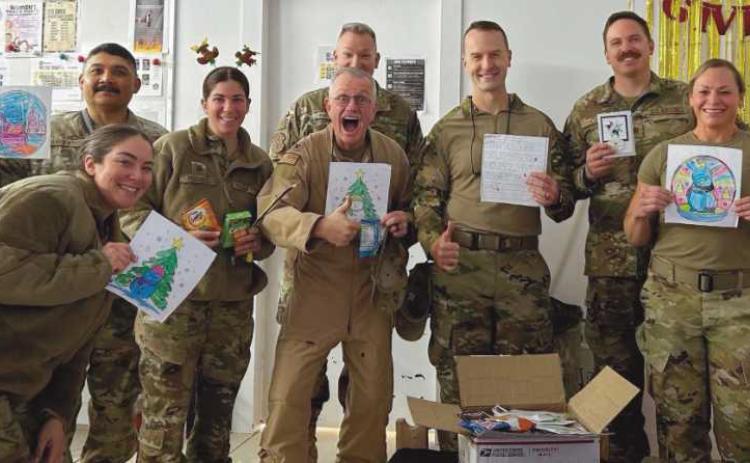 Every year, Rossford Elementary first graders send pictures and letters to local service personnel posted overseas. These pictures and letters were packaged at All Saints Church by the RHS Serving Our Soldiers Club. This photo was sent back from soldiers serving in Saudi Arabia.