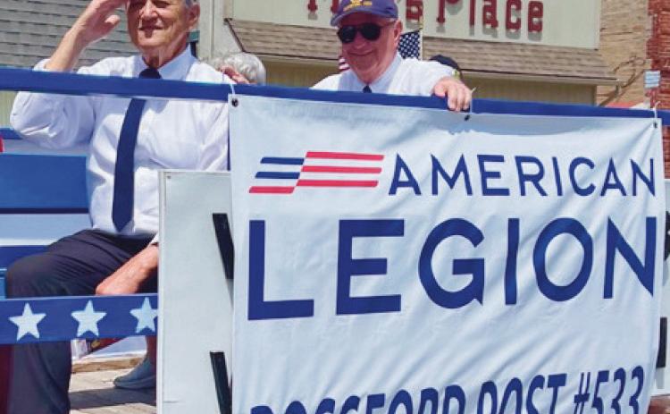 Joseph “Moe” Minarcin and David Weaks, American Legion members, upon the float during the parade.