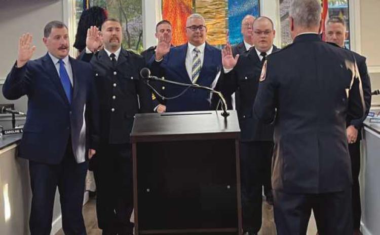 Full-time firefighters, from left: Zachary Bernhard, Zachery Moore, Ryan Goodrick, Michael Roberts and Josh Walters, being sworn in by Fire Chief Rick Syroka (with back toward camera). Assistant Chief Ron Kay and Mayor Neil MacKinnon III can be seen in the background.