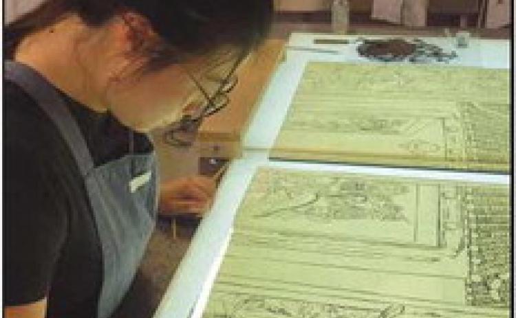 The three artists provided photos of their work in progress. Above is Ms. Song as she designs the piece. Bottom left is Mr. Rosenberg’s work, and middle left is that of Mr. Corr.
