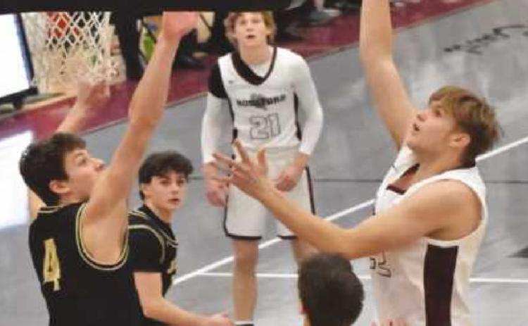 Derek Vorst goes up for the shot during the Perrysburg game. The junior post player tallied 10 points in the opening quarter with two three-point shots and a dunk. Photo by John Bauer