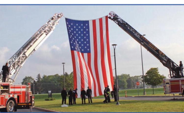 Perrysburg Township and Pemberville fire departments raise the American flag with assistance from Penta’s criminal justice students.