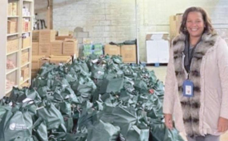 Dawn Burks with food supplies for students in need.
