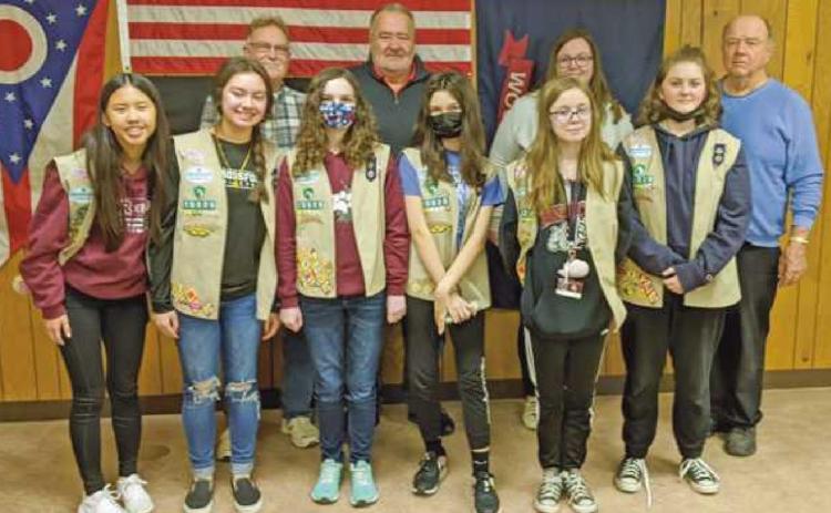 With members of Girl Scout Troop 10020, are, in the back row, Trustees Gary Britten and Joe Schaller, fiscal officer Hannah Nelson and recreation director Bob Warnimont. The scouts delivered cookies as an expression of gratitude to township officials for allowing them to use the facilities for delivery and distribution of cookies for their annual sale.