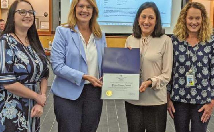 The treasurerʼs department accepts a certificate from the Ohio auditor of stateʼs office for having a perfect audit. From left are Alexis Piper, assistant to the treasurer/accounts payable; Lorie Brodie of the state auditorʼs office; Penta treasurer Carrie Herringshaw and Amy Seibel, assistant treasurer.