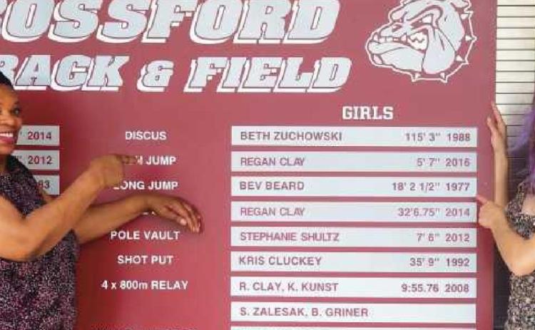 Former school record-holder Beverly (Beard) Paige, left, points to her name on the list, which will be replaced by senior Clare Logan, right and below.