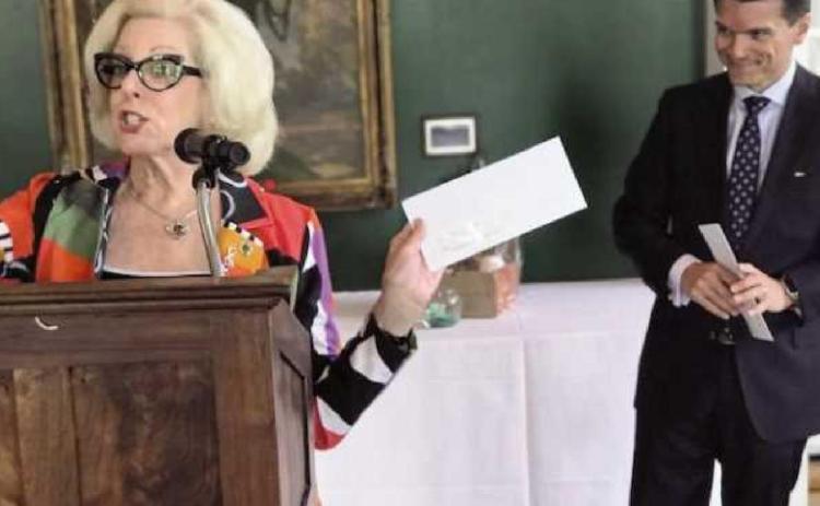 Toledo Symphony League president Marlene Uhler presents a $30,000 check from league fund-raising efforts to symphony CEO Zak Vassar.