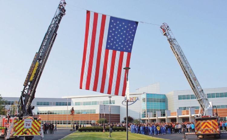 Perrysburg Township and Pemberville fire departments raise the American flag prior to the ceremony at Penta Career Center.
