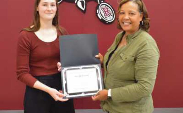 Dawn Burks, school board president, presents Mia DeBortoli with a commendation for her accomplishments in track and field. This year, Mia qualified for state in the 200m by finishing fourth at regionals. Her 4x200m relay team finished second in the Northern Buckeye Conference to qualify for regionals. Mia also finished First Team All-NBC in 200m; received honorable mention in the NBC 100m, and played on the varsity girls basketball team.