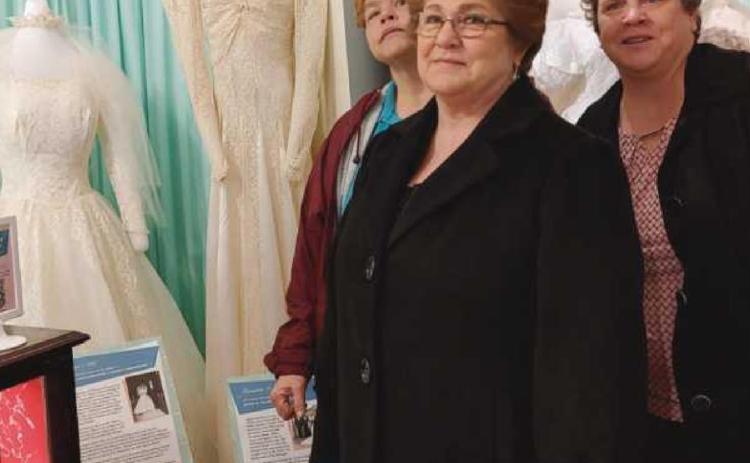 Carol Warnimont, center, is flanked by her daughters Julie and Cathy. Mrs. Warnimont’s dress is on the left and her aunt’s dress is on the right.