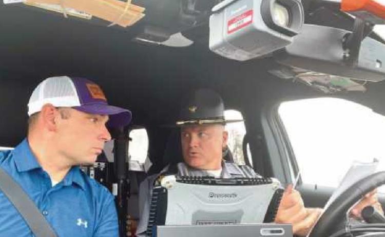 Above, Rep. Ghanbari sits in the front seat of a patrol car last summer during a ride-along with Ohio Highway Patrol Trooper Casimir Von Sacken in Bowling Green during an overnight shift.
